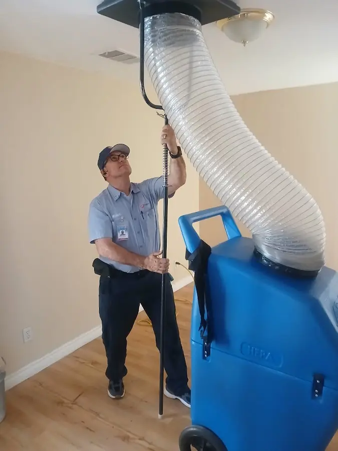 Furnace Tune-Up technician using HEPA equipment in Box Elder